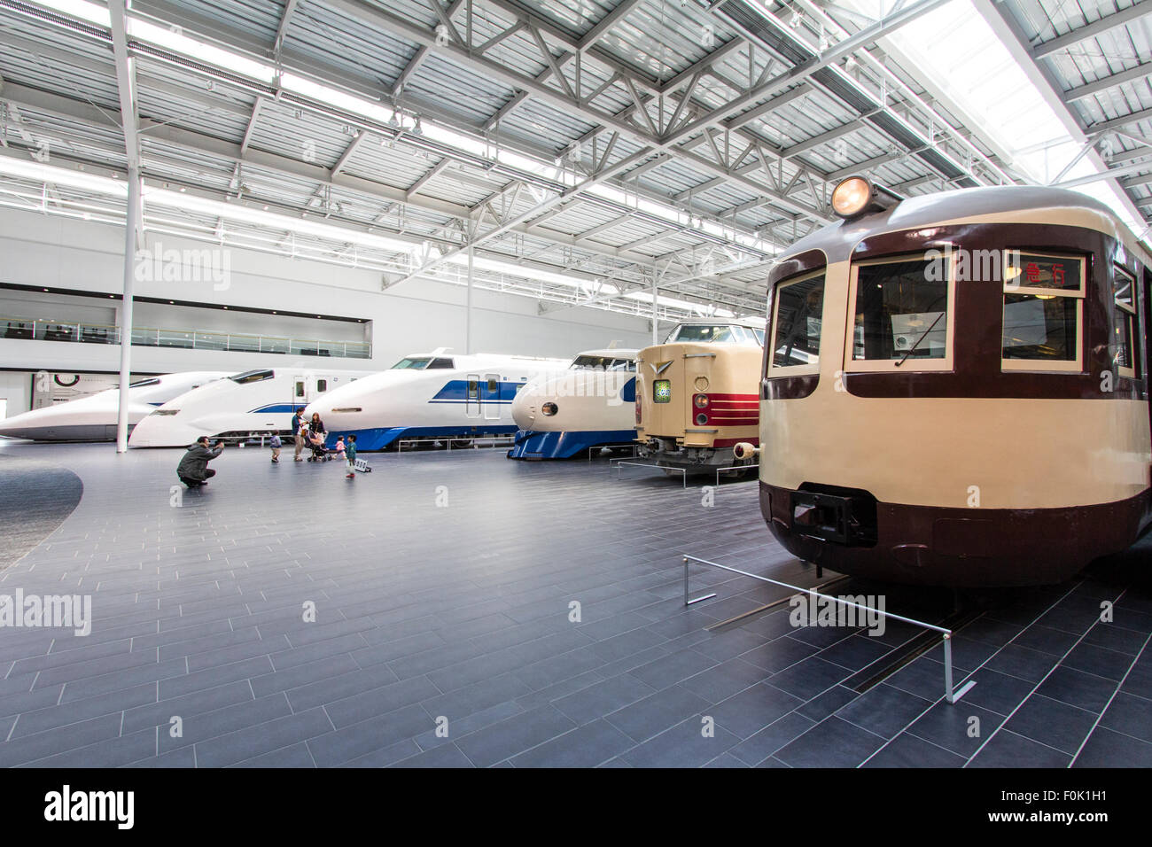 Japan, Nagoya, Railway park. Shinkansen Museum. Nearest is a Class Moha 52 electric railcar and beyond, an express and four different bullet trains. Stock Photo