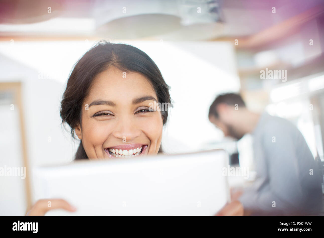 Close up portrait smiling woman using digital tablet Stock Photo