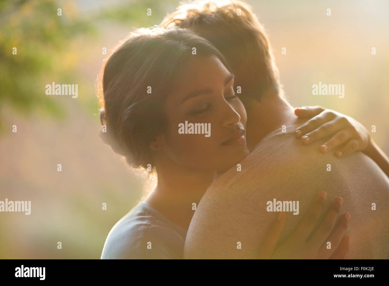 Close up serene couple hugging Stock Photo