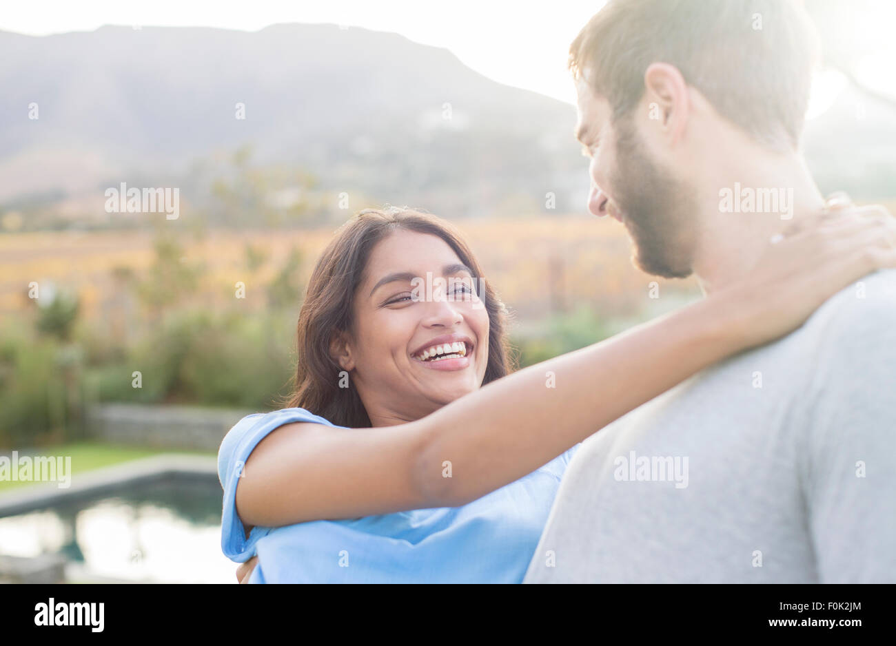 Enthusiastic couple hugging outdoors Stock Photo