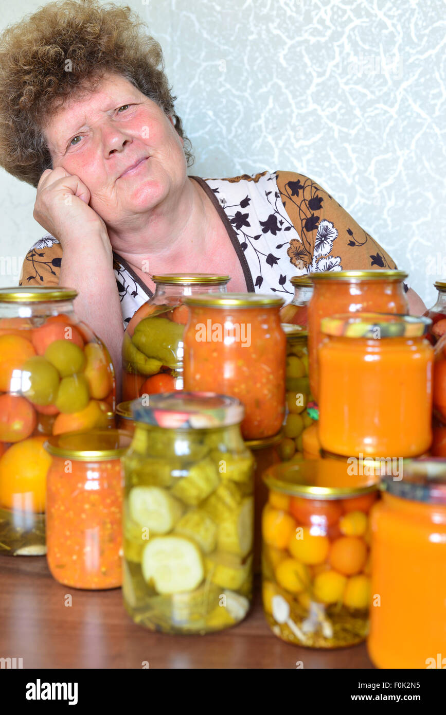 Mature housewife with home canned vegetables Stock Photo