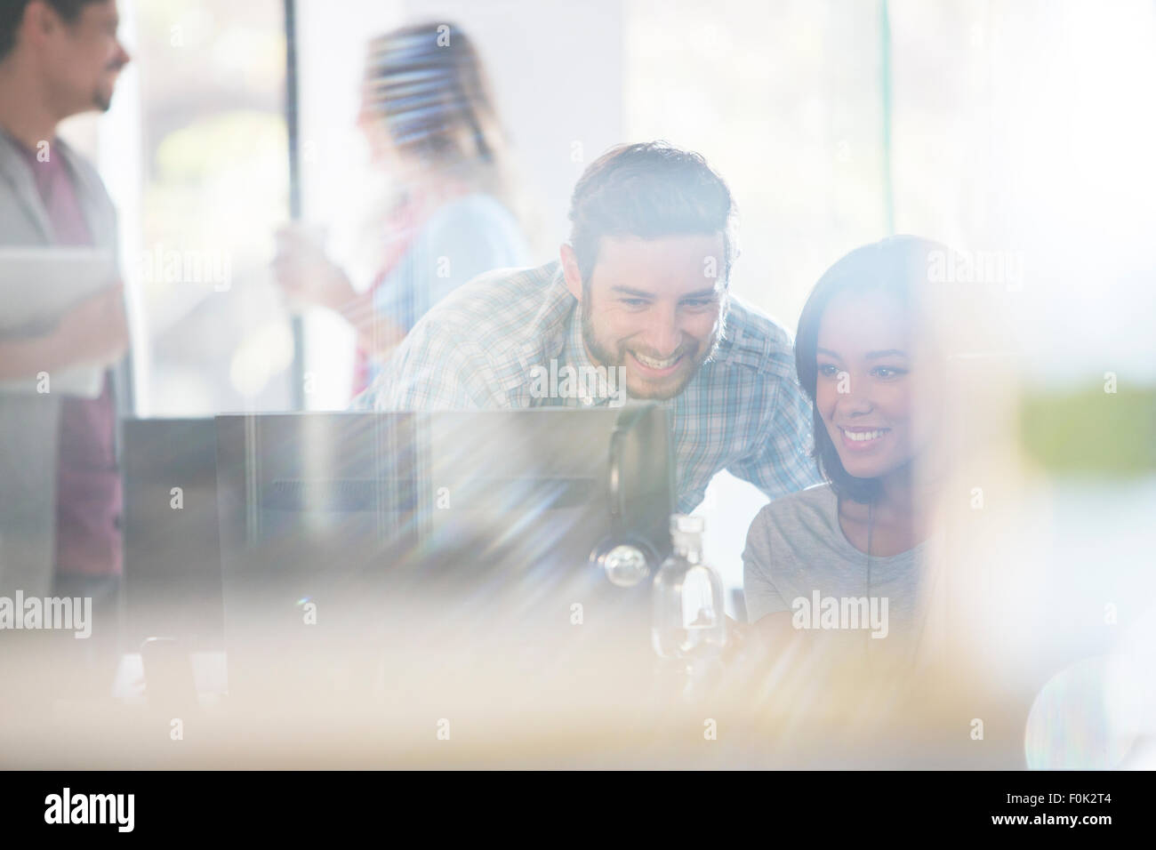 Creative business people using computer in office Stock Photo - Alamy