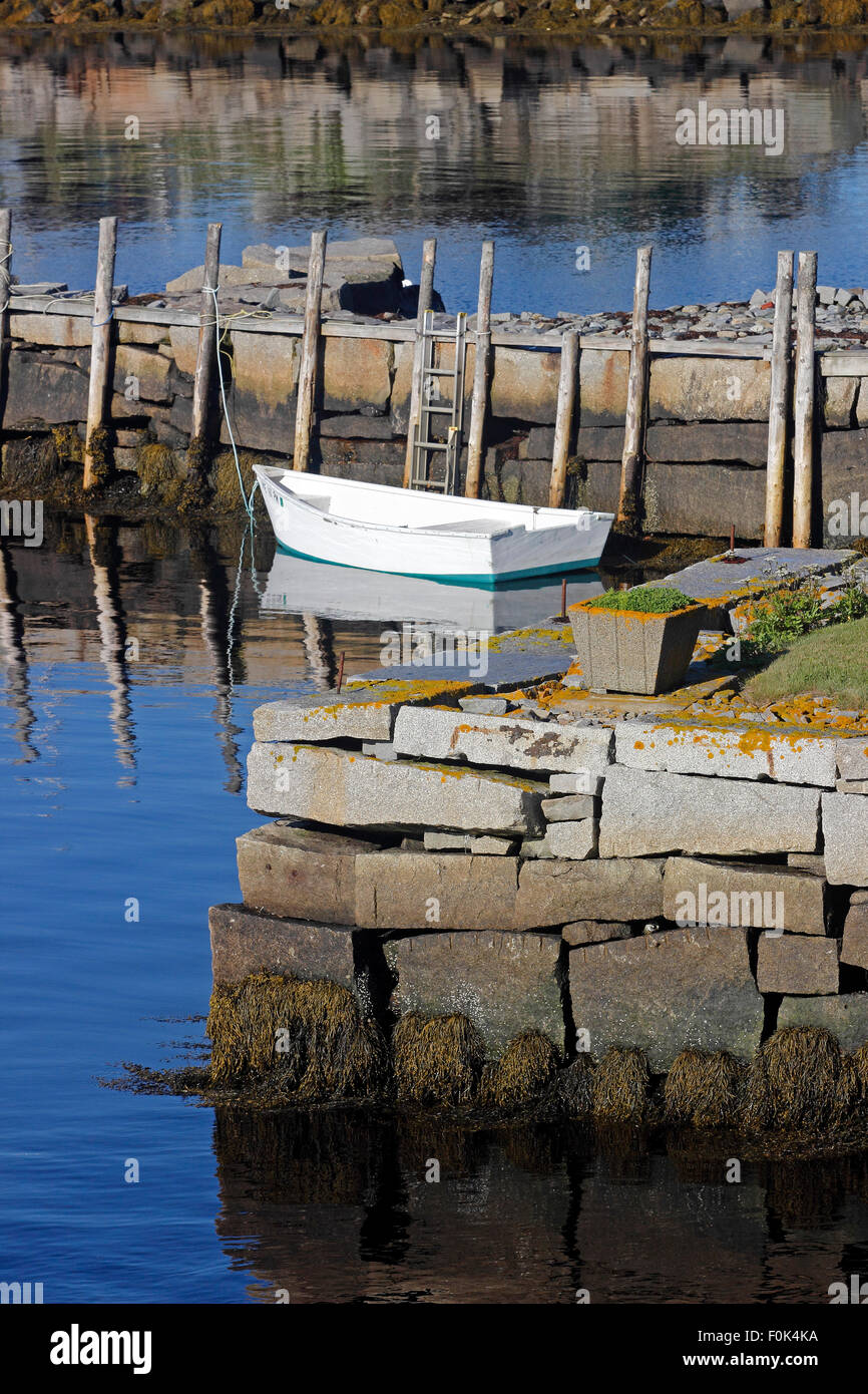 White dingy and granite wharfs in harbor Vinalhaven Island Maine New