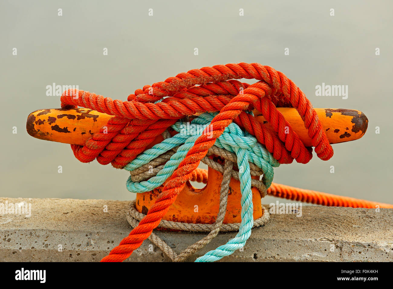 Mooring bollard with rope on pier by the sea. Stock Photo