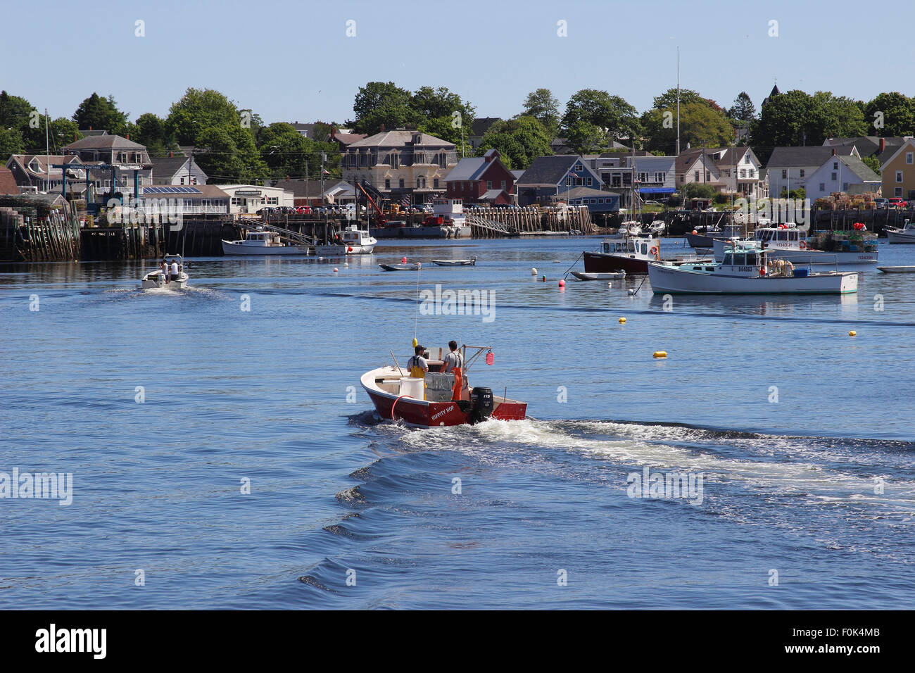 Lobster boat returning to dock waterfront Vinalhaven Island Maine New