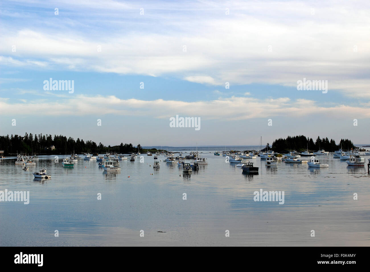 Lobster boats on moorings in harbor waterfront Vinalhaven Island Maine