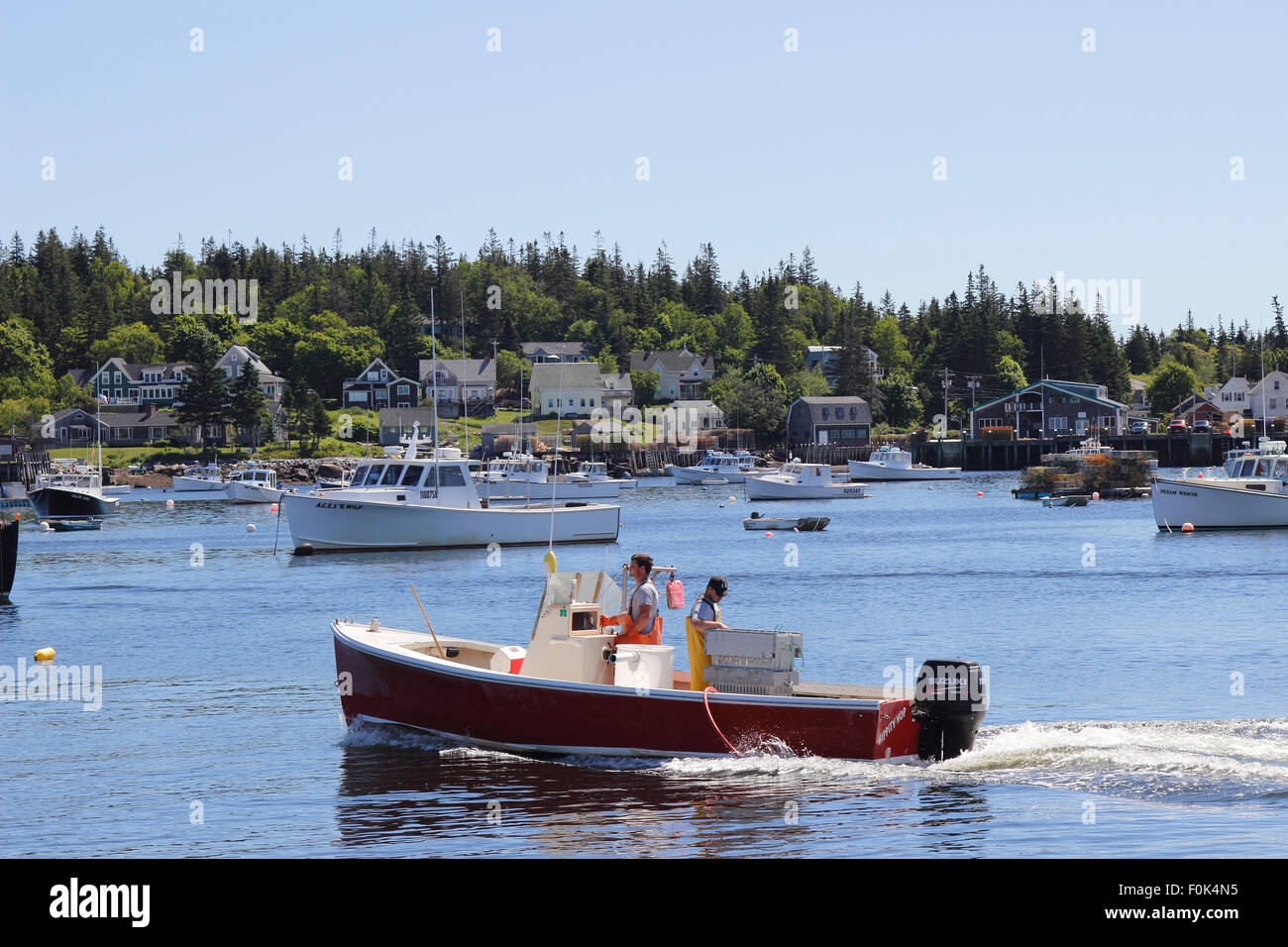 Lobster boat returning to dock waterfront Vinalhaven Island Maine New