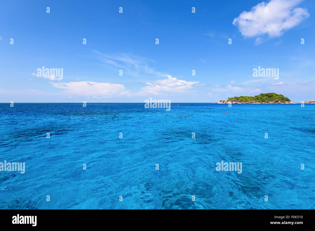 Beautiful landscape of clear sky over small island and blue sea middle Andaman Ocean in summer at Mu Koh Similan National Park, Stock Photo