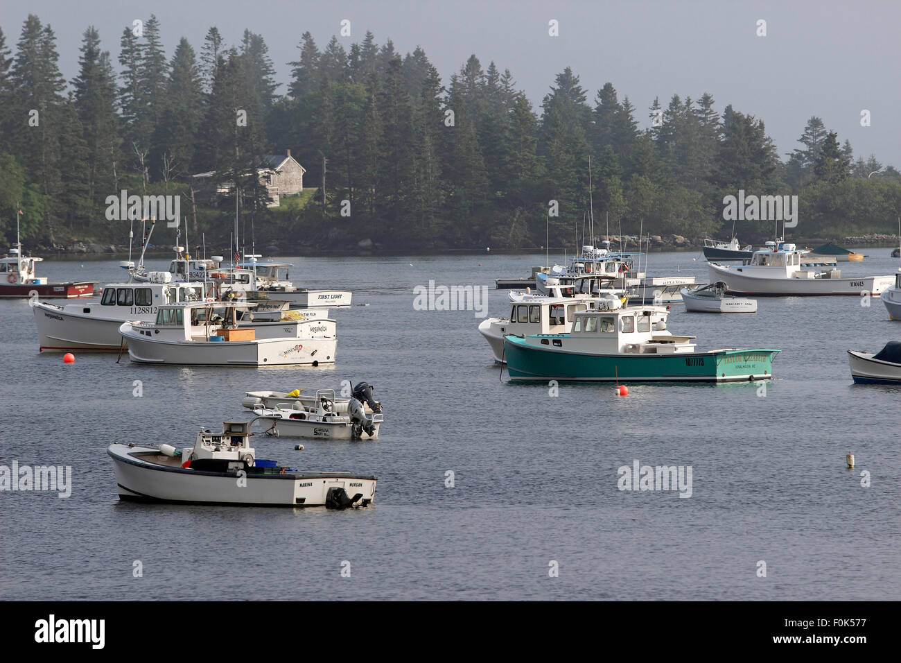 Lobster boats on moorings in harbor waterfront Vinalhaven Island Maine