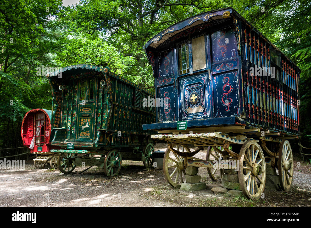 Traditional old Romany gypsy caravans in a woodland clearing at Groombridge Place, Tunbridge Wells, Kent, England Stock Photo