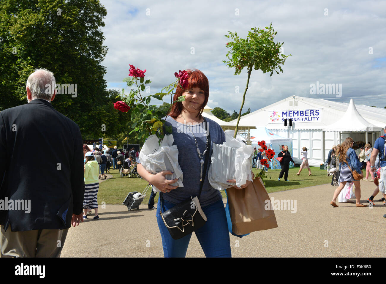 Woman carrying buying flowers and plants at Shrewsbury Flower Show 2015 Stock Photo