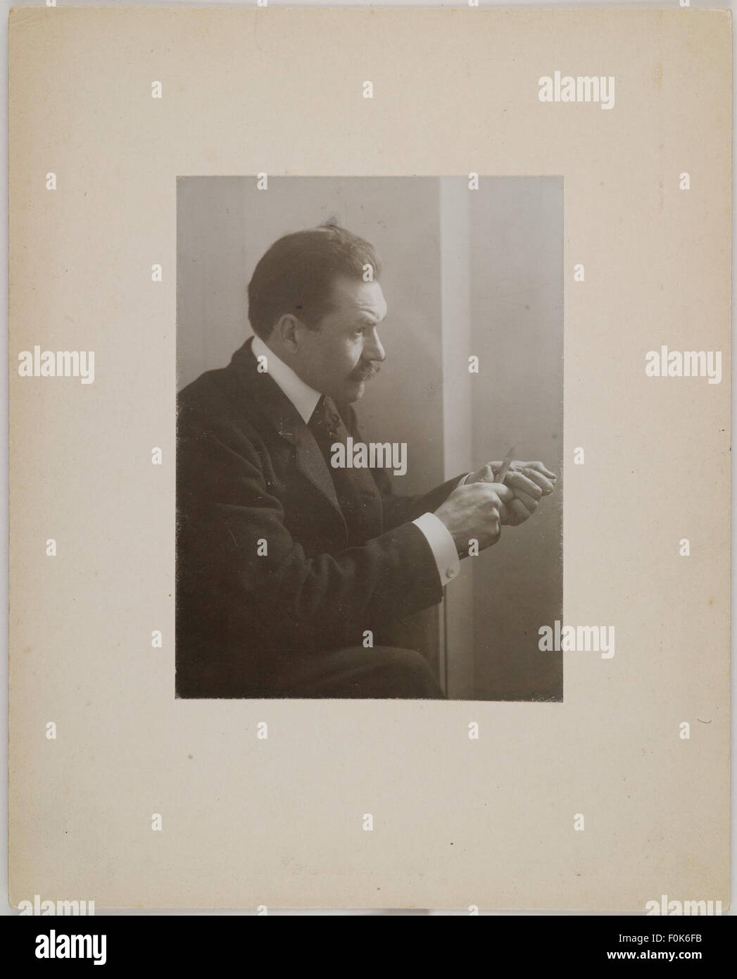 Axel Gallén, wearing a suit, carving wood, in Vienna, ca.1907; photograph with a frame. Axel Gallén, wearing a suit, carving wood, in Vienna, ca1907; Stock Photo