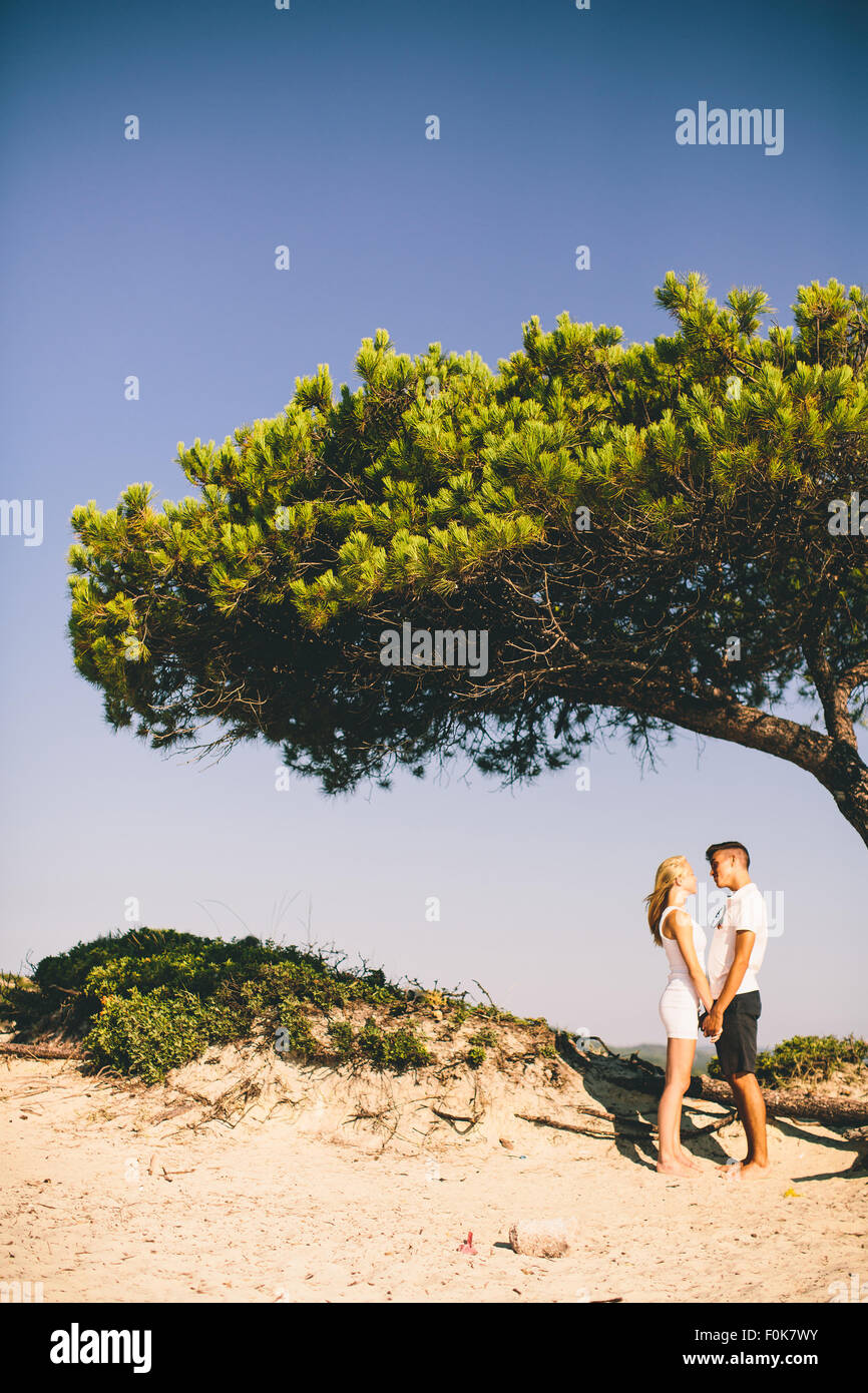 Young couple relaxing on the beach Stock Photo