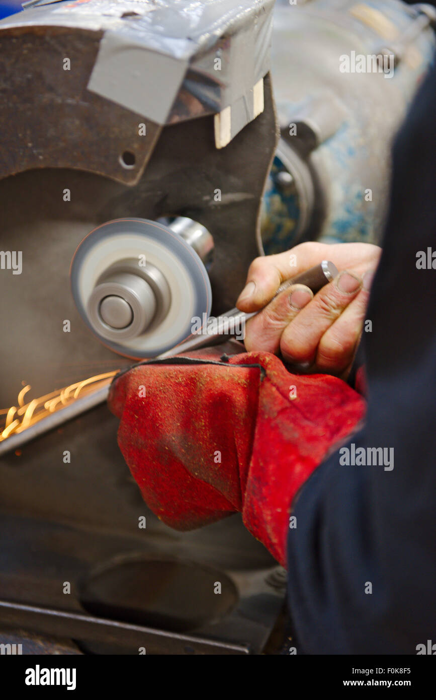 Tool grinding during the manufacturing process of making a wood turning gouge Stock Photo