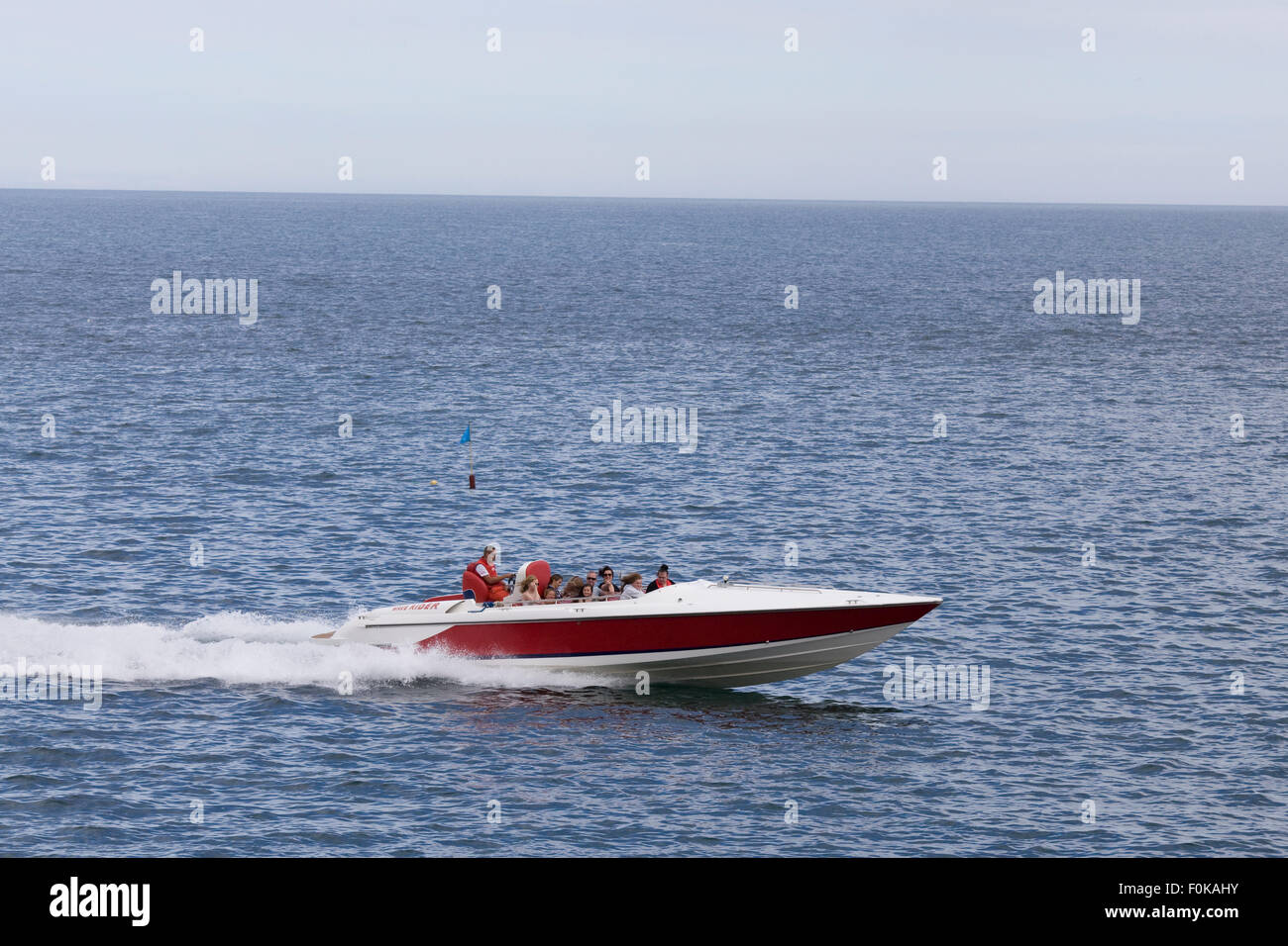 Passenger speed boat speeding across the ocean Stock Photo
