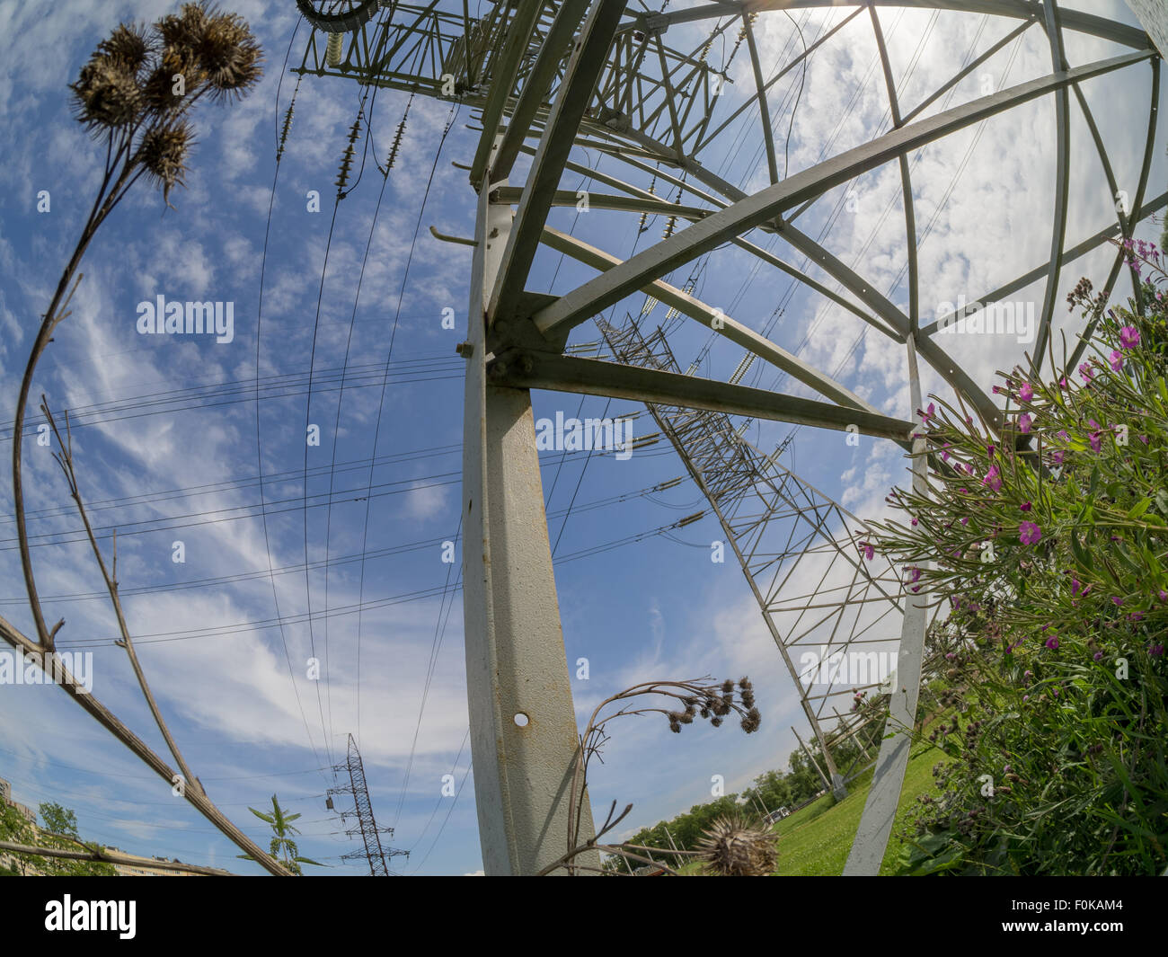 a high voltage power pylons against blue sky Stock Photo - Alamy