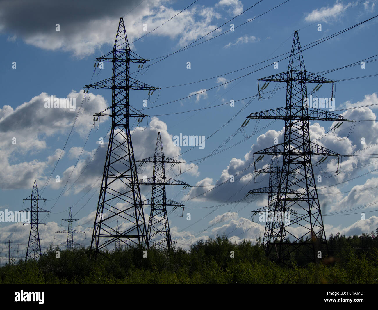 a high voltage power pylons against blue sky Stock Photo - Alamy