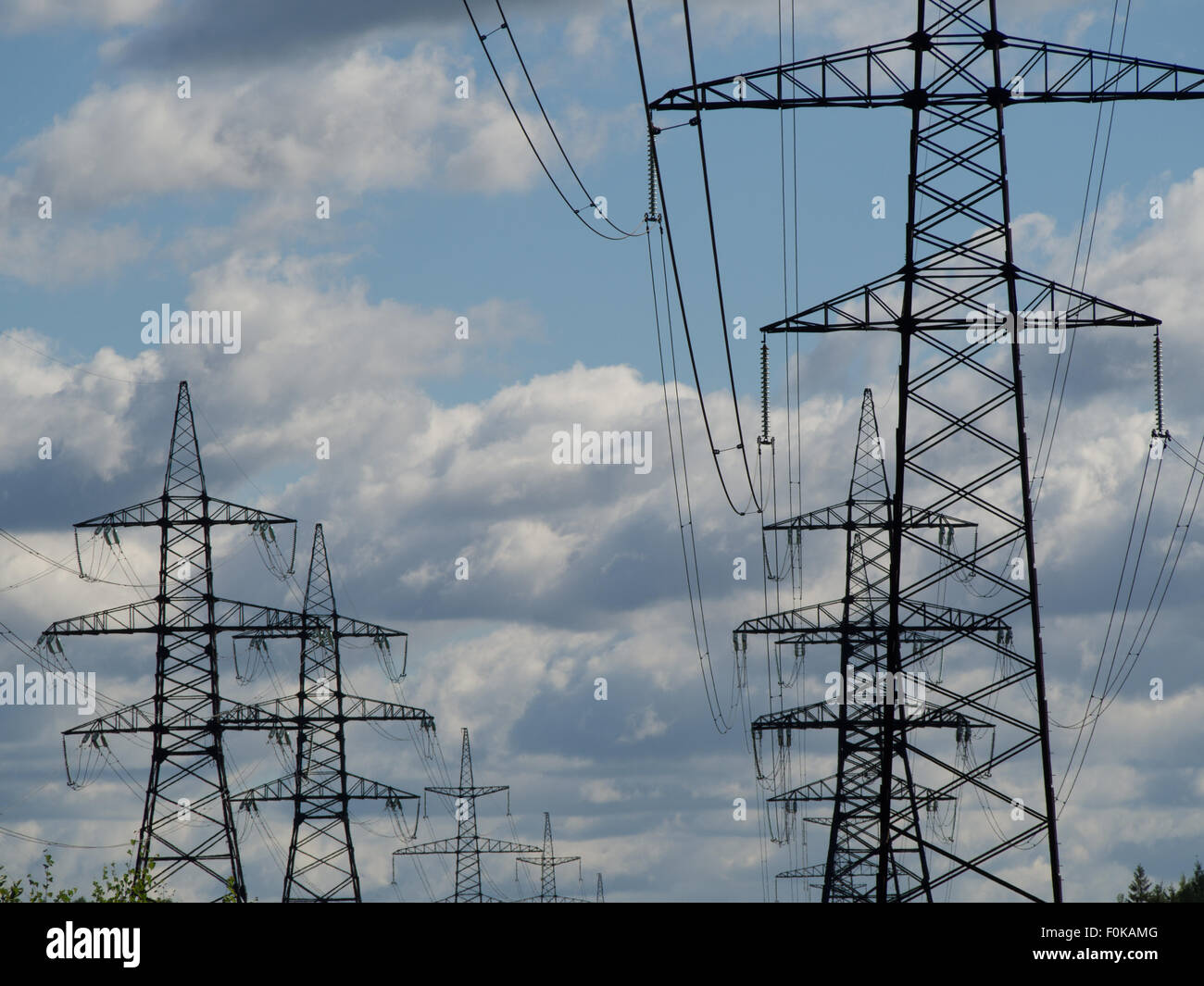 a high voltage power pylons against blue sky Stock Photo - Alamy