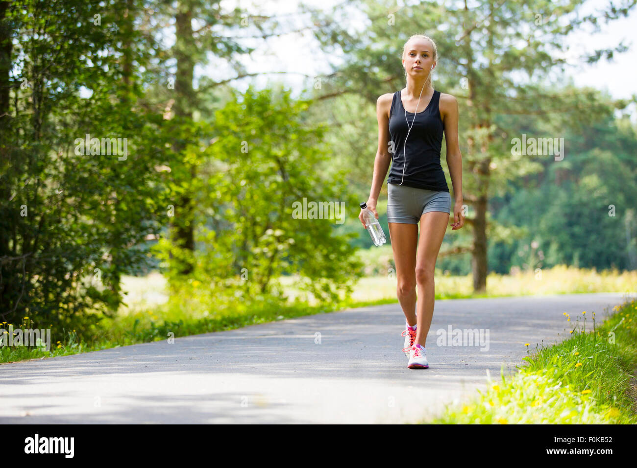 Young woman walks outdoor as workout Stock Photo
