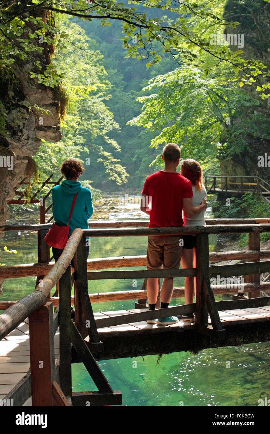 Tourists admiring the view at Vintgar Gorge, Slovenia. Travel, tourism and lifestyle in Europe. Stock Photo
