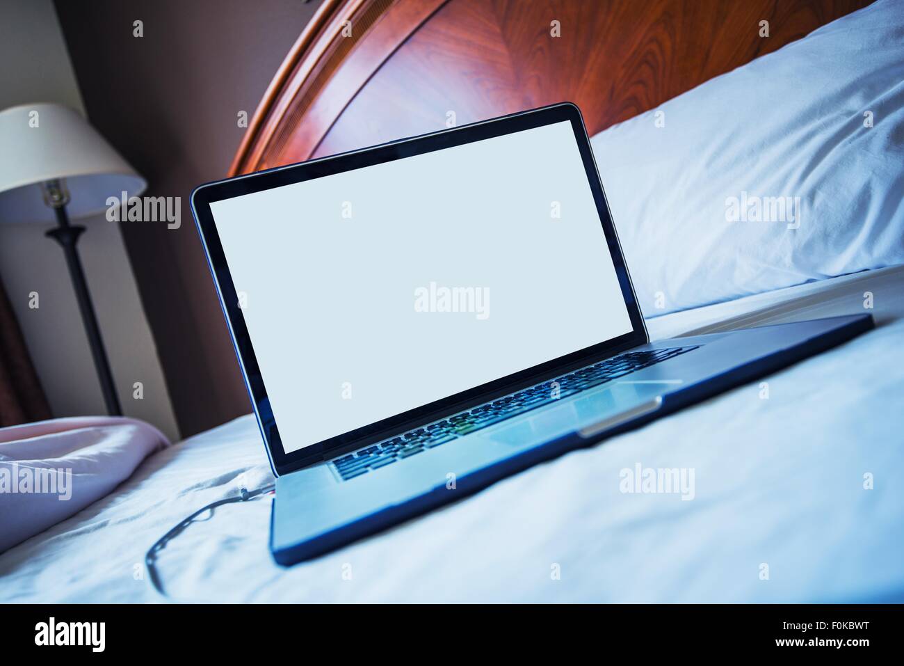 Computer in Bed Concept Photo. Browsing and Working From Bed