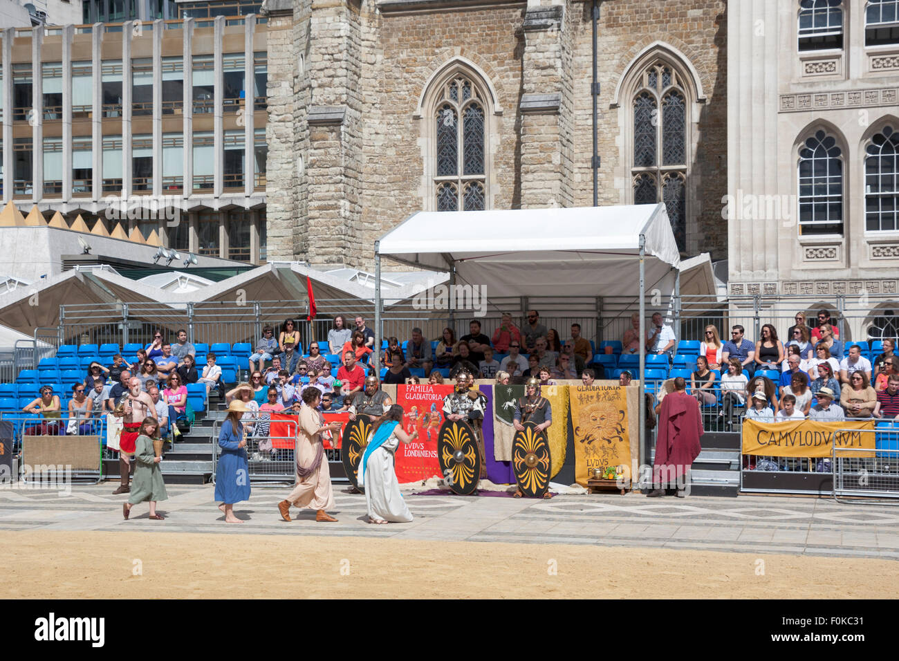London, UK. 16th August, 2015. Live action Gladiator show at the Guildhall Yard. Professional gladiators battle it out in Guildhall Yard, the site of London's only Roman amphitheatre. The reconstructions of the gladiator-style games once held in ancient Londinium took place before an emperor and cheerful crowd who decide which warrior will get to walk free based on their performance. Credit: Nathaniel Noir/Alamy Live News Stock Photo