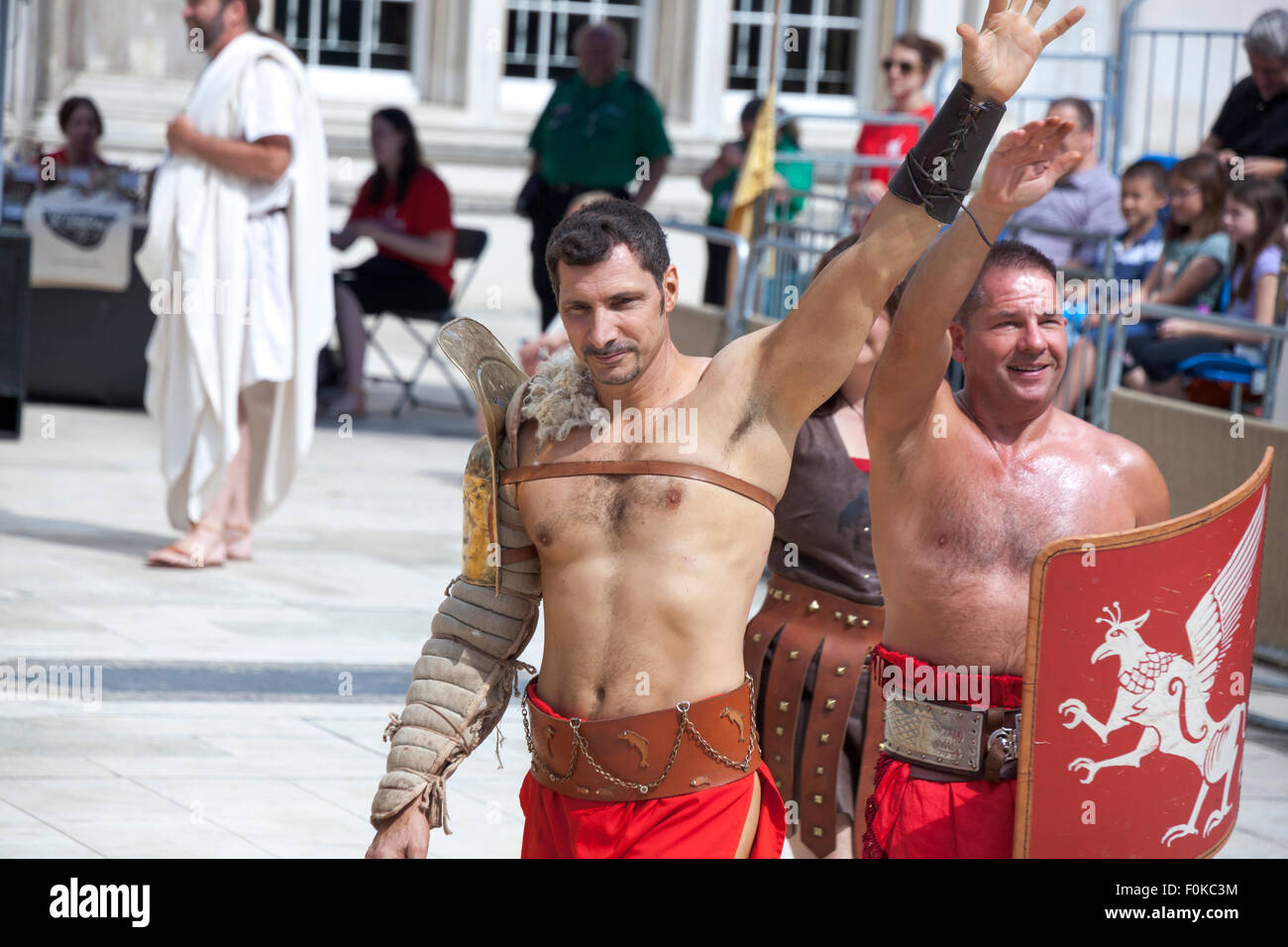 London, UK. 16th August, 2015. Live action Gladiator show at the Guildhall Yard. Professional gladiators battle it out in Guildhall Yard, the site of London's only Roman amphitheatre. The reconstructions of the gladiator-style games once held in ancient Londinium took place before an emperor and cheerful crowd who decide which warrior will get to walk free based on their performance. Credit: Nathaniel Noir/Alamy Live News Stock Photo