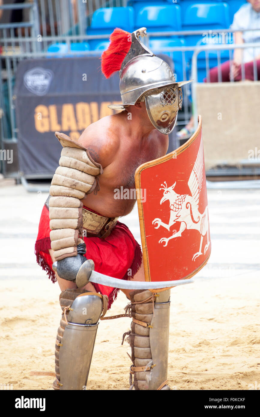 London, UK. 16th August, 2015. Live action Gladiator show at the Guildhall Yard. Professional gladiators battle it out in Guildhall Yard, the site of London's only Roman amphitheater. The reconstructions of the gladiator-style games once held in ancient Londinium took place before an emperor and cheerful crowd who decide which warrior will get to walk free based on their performance. Credit: Nathaniel Noir/Alamy Live News Stock Photo