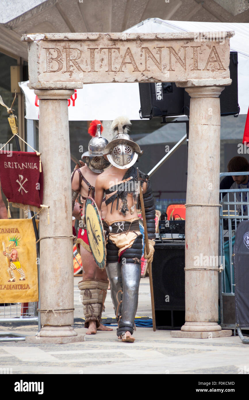 London, UK. 16th August, 2015. Live action Gladiator show at the Guildhall Yard. Professional gladiators battle it out in Guildhall Yard, the site of London's only Roman amphitheatre. The reconstructions of the gladiator-style games once held in ancient Londinium took place before an emperor and cheerful crowd who decide which warrior will get to walk free based on their performance. Credit: Nathaniel Noir/Alamy Live News Stock Photo