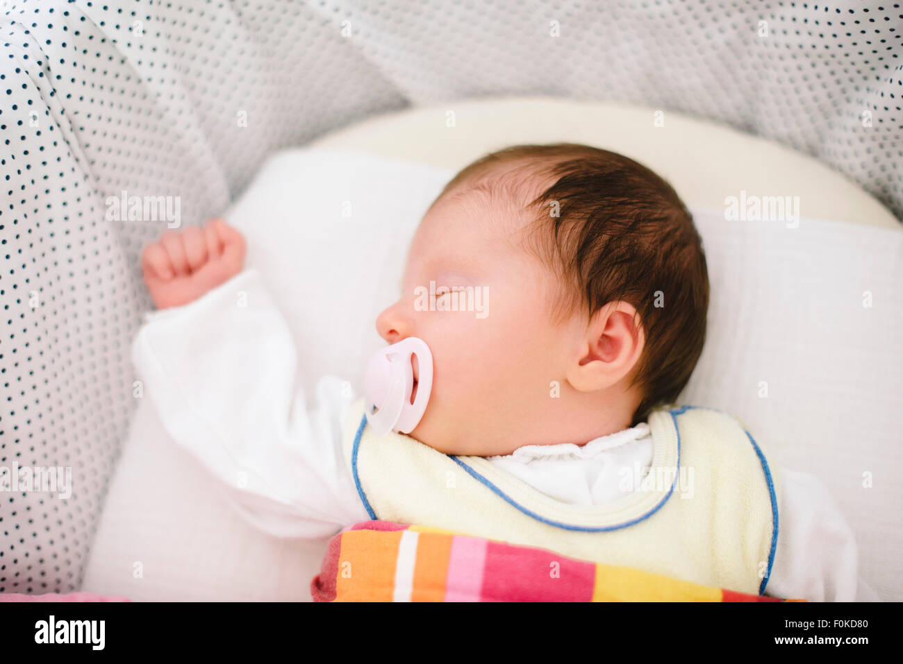 Sleeping newborn baby girl with pacifier Stock Photo