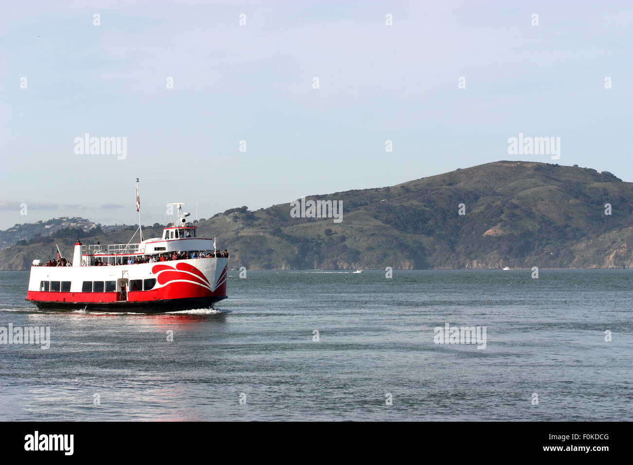 Boat with Passengers cruising on Pacific Ocean Stock Photo