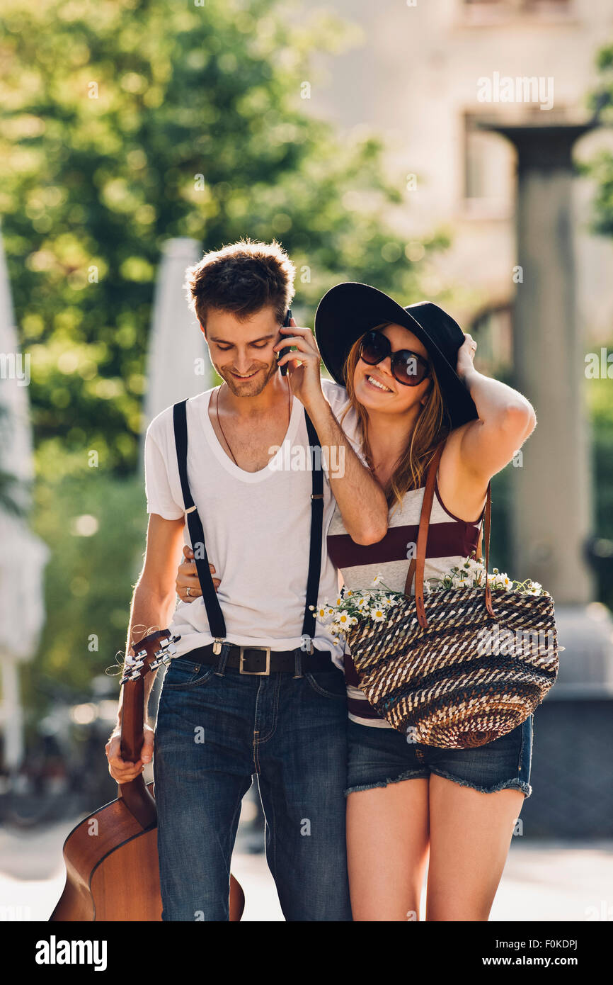 Portrait of young couple walking on the street Stock Photo - Alamy