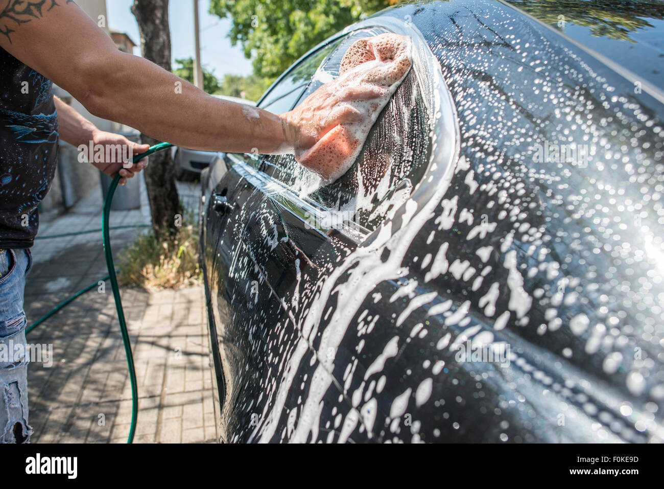 Man washing his car, closeup Stock Photo Alamy