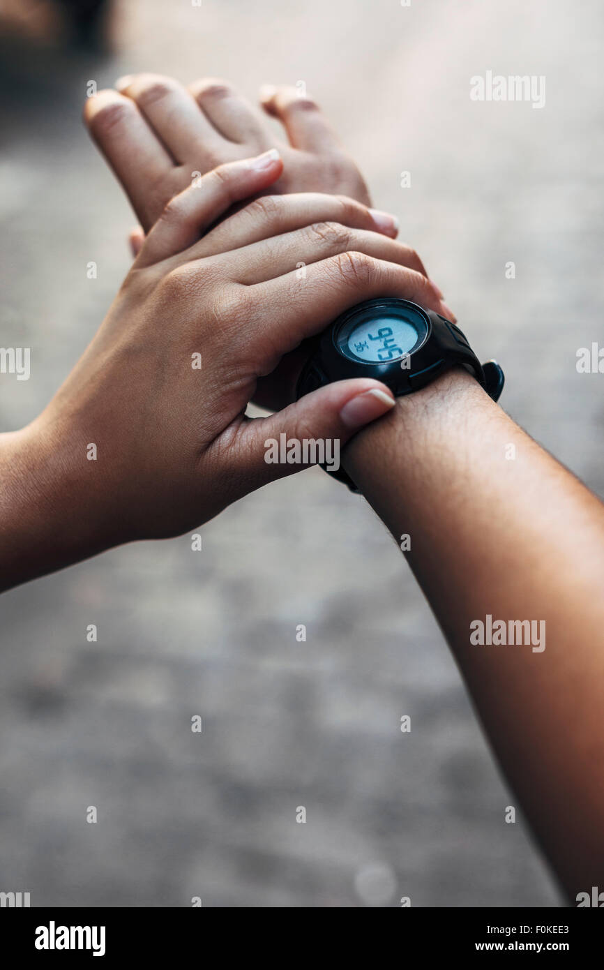 Arms of young woman with wrist watch, close-up Stock Photo