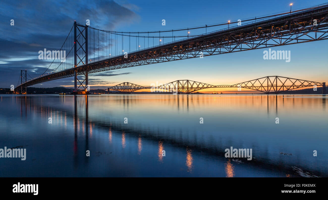 Sunrise over the Forth Bridges from Port Edgar Marina, South Queensferry, Scotland UK on a calm morning Stock Photo