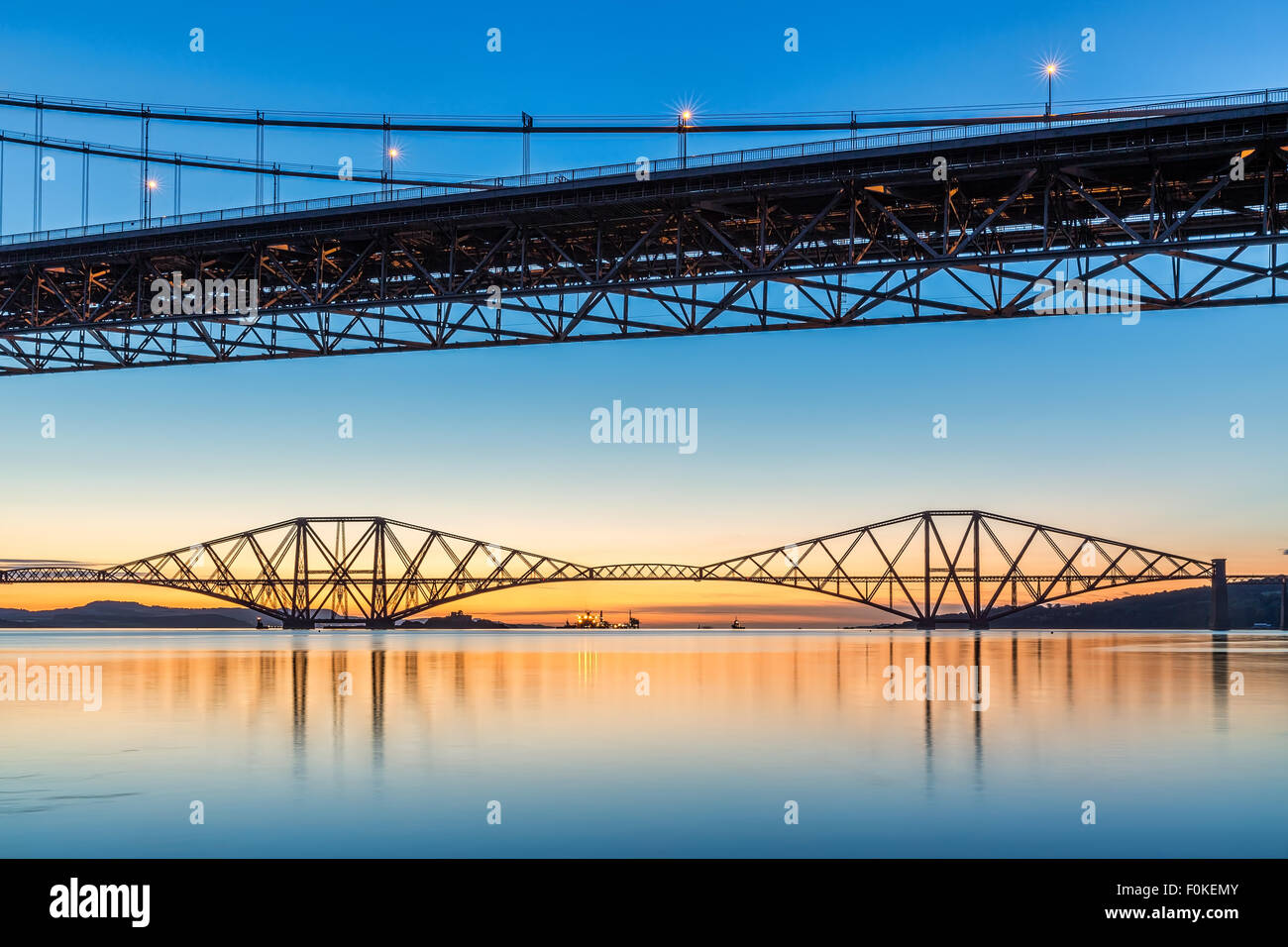 Sunrise over the Forth Bridges from Port Edgar Marina, South Queensferry, Scotland UK on a calm morning Stock Photo