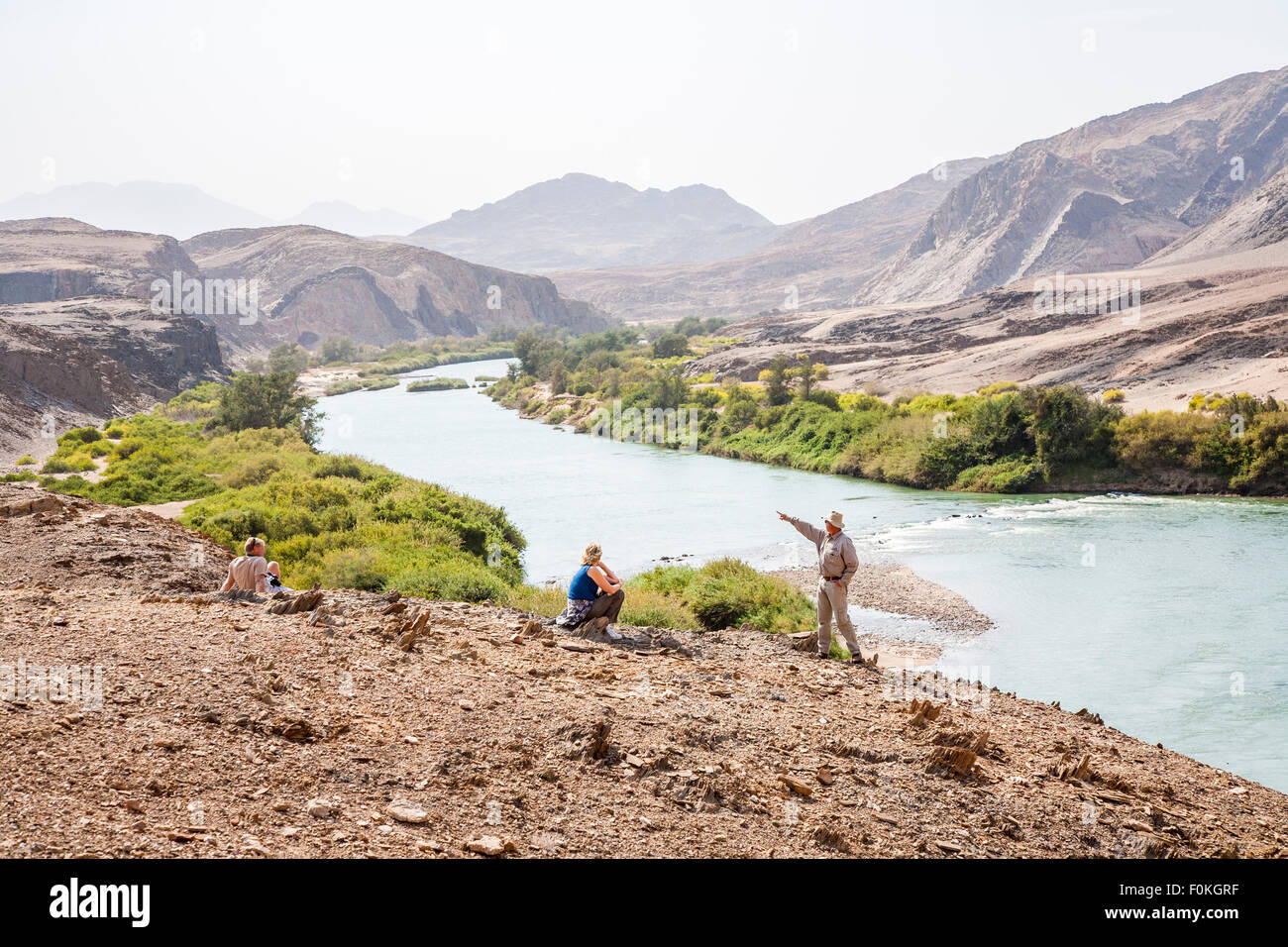 Tourists ang guide on the riverbank of Cunene River (or Kunene River