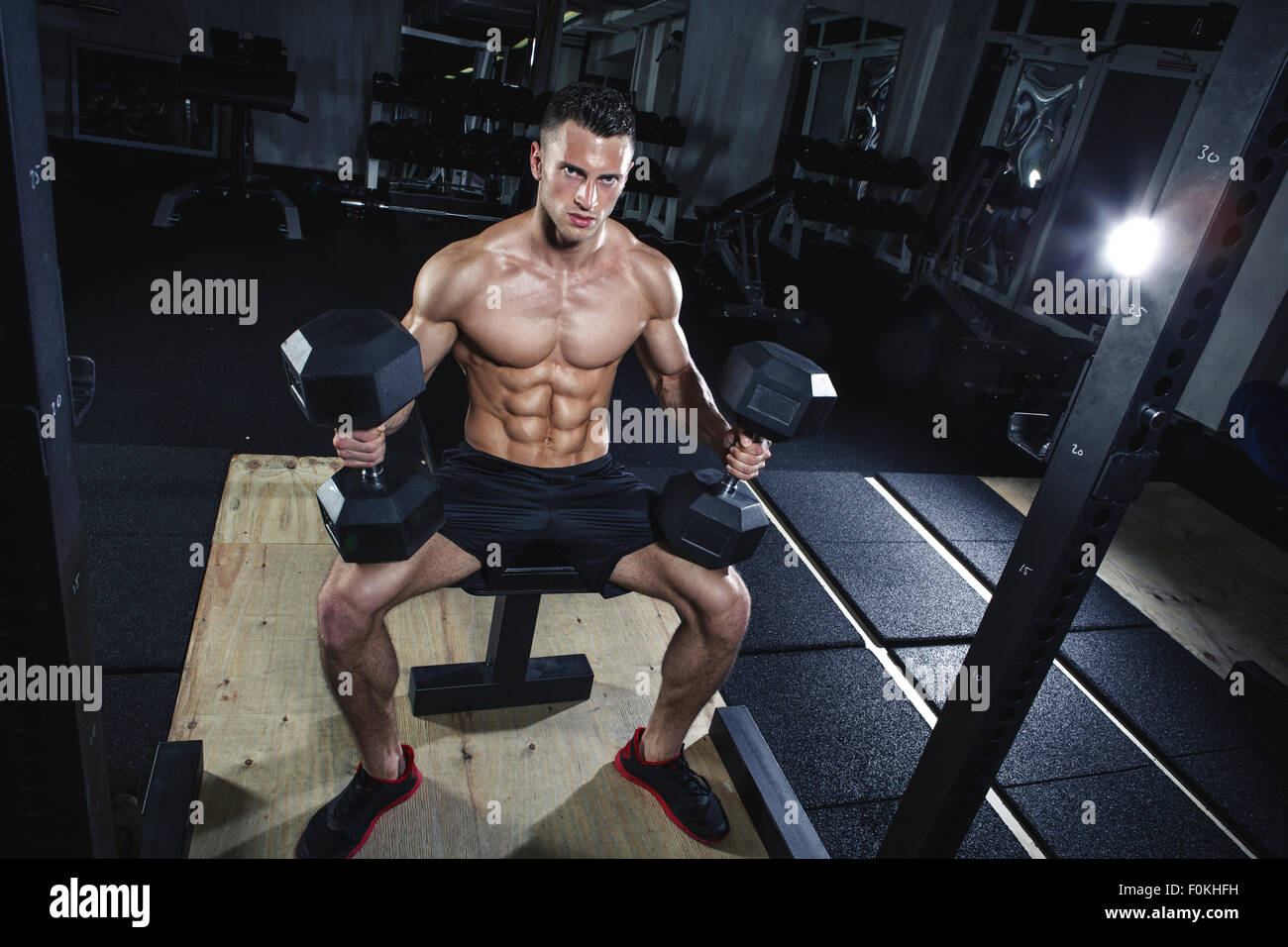 Physical athlete doing dumbbell bench presses Stock Photo Alamy