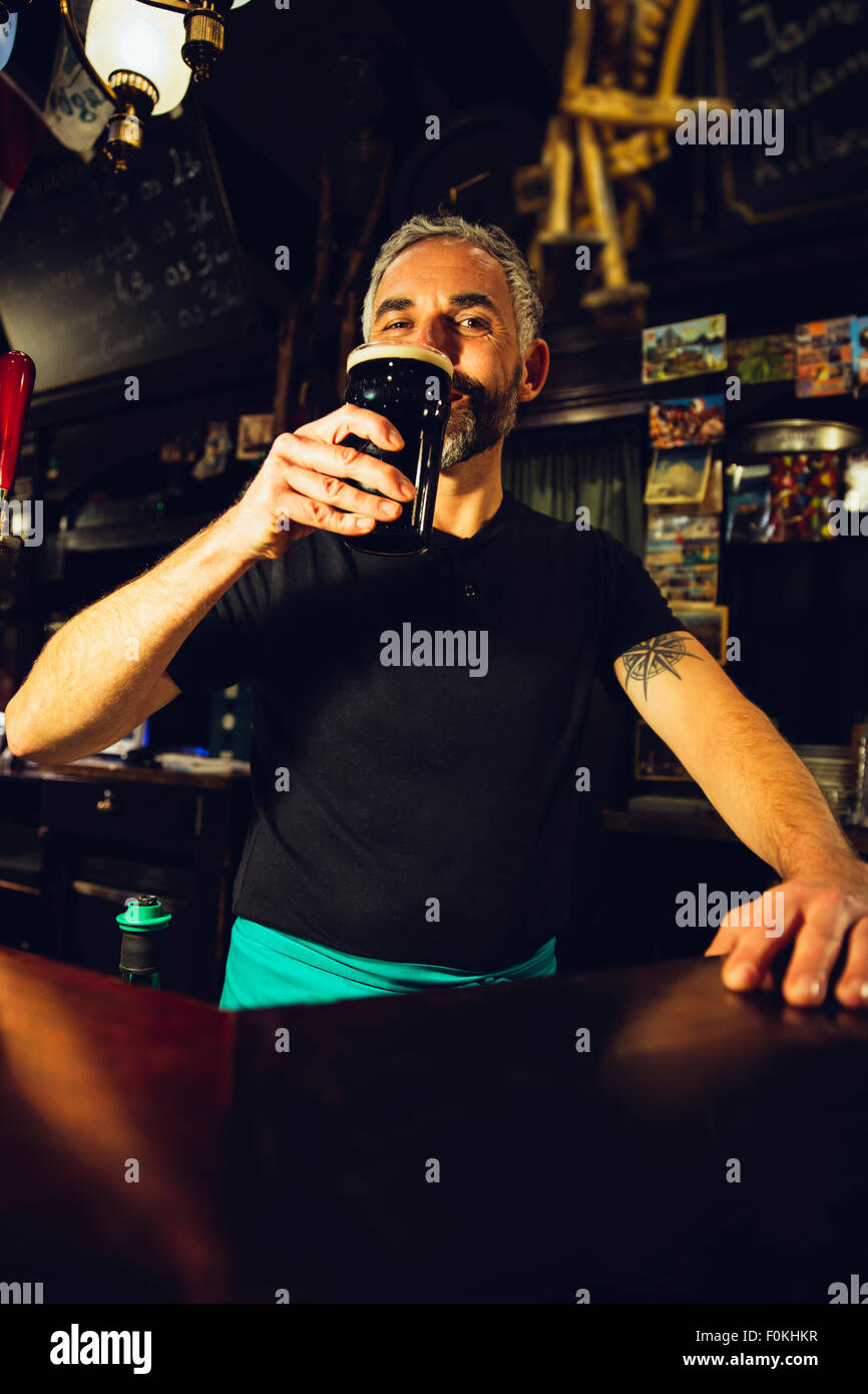 Waiter Drinking Beer In An Irish Pub Stock Photo Alamy