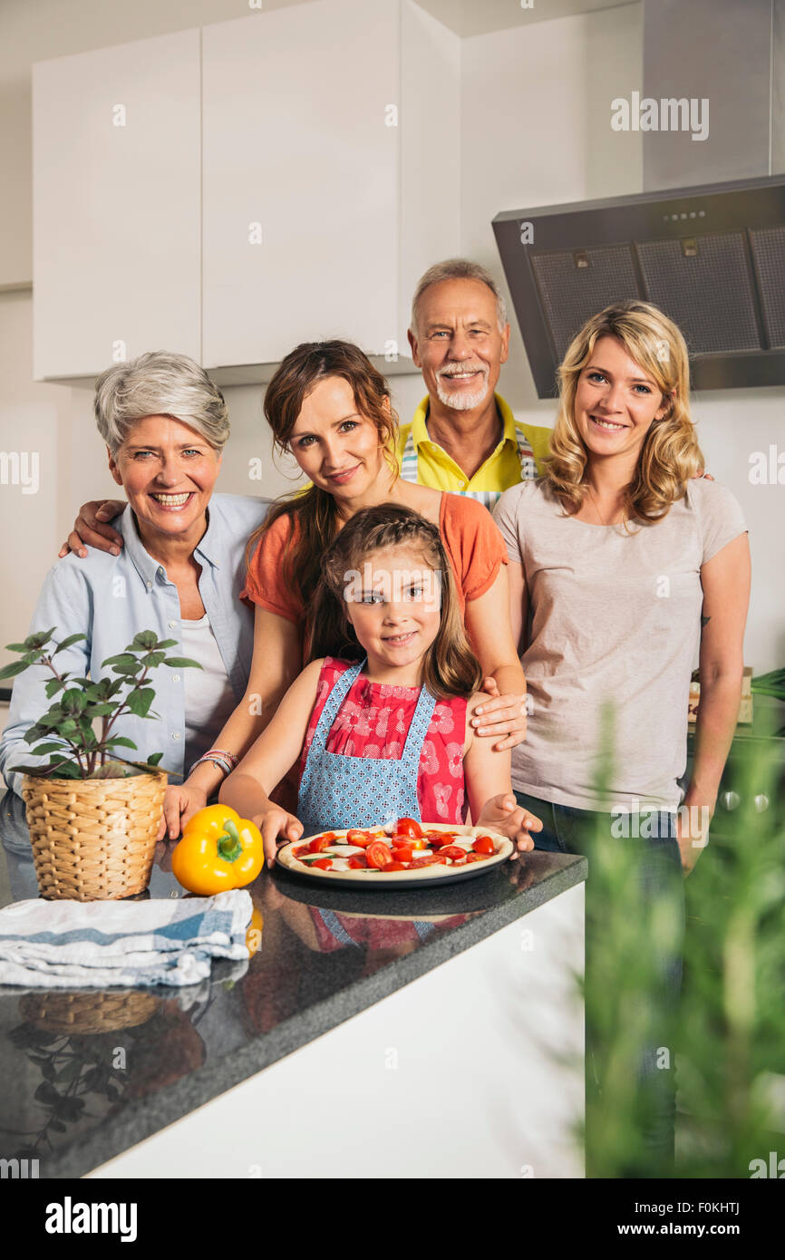 Group picture of three generations family in the kitchen Stock Photo