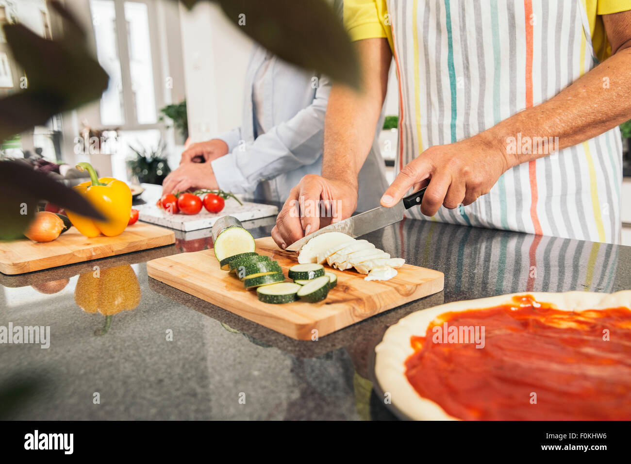 Couple cutting vegetables in the kitchen Stock Photo