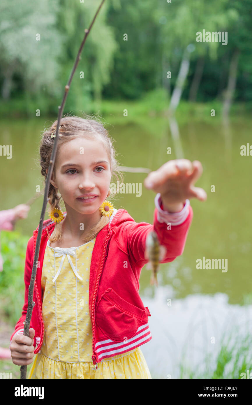 Girl with rod and small fish hi-res stock photography and images