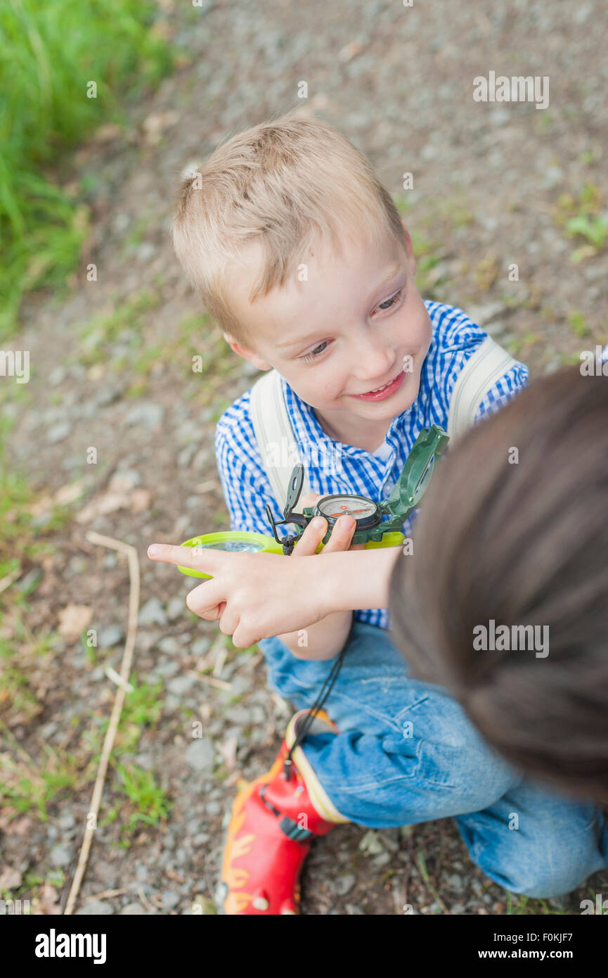 Germany, Boy learning how to use compass Stock Photo - Alamy