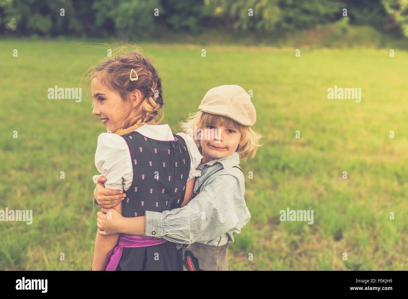 Premium Photo  Little boy and girl play in field kids in summer meadow  family vacation in the country siblings love