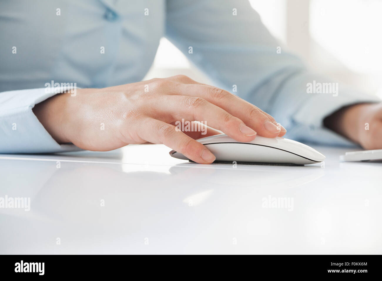 Close-up of woman's hand using computer mouse Stock Photo - Alamy