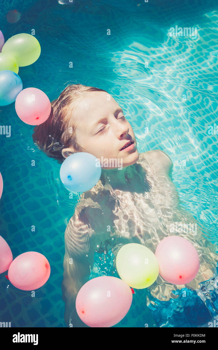 Boy floating with balloons hires stock photography and images Alamy