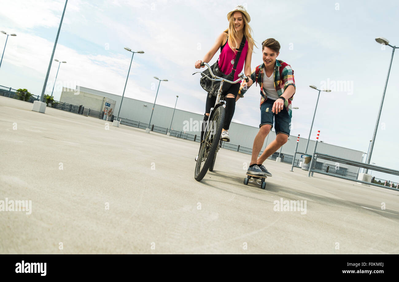 Happy young couple with bicycle and skateboard Stock Photo