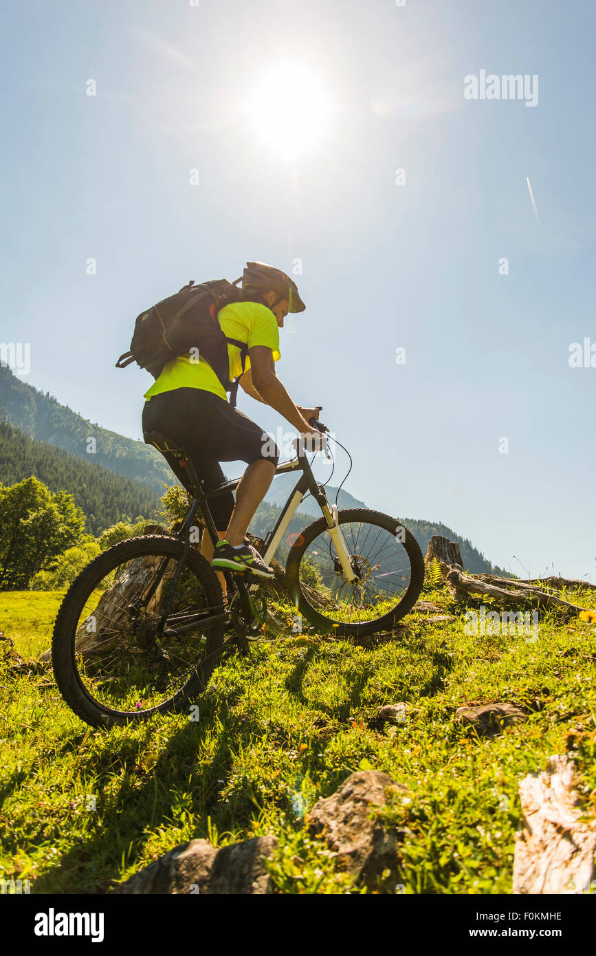 Austria, Tyrol, Tannheim Valley, young man on mountain bike in alpine landscape Stock Photo