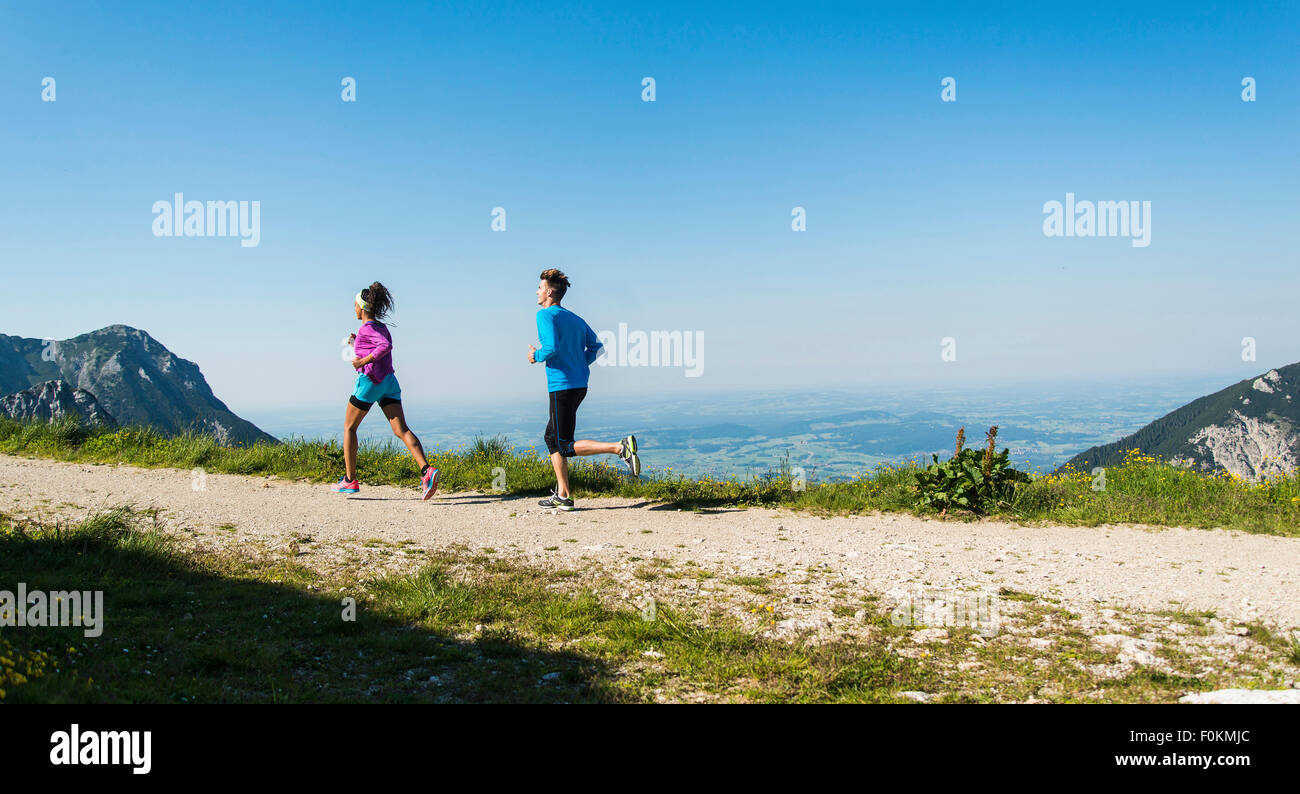 Austria, Tyrol, Tannheim Valley, young couple jogging in mountains Stock Photo