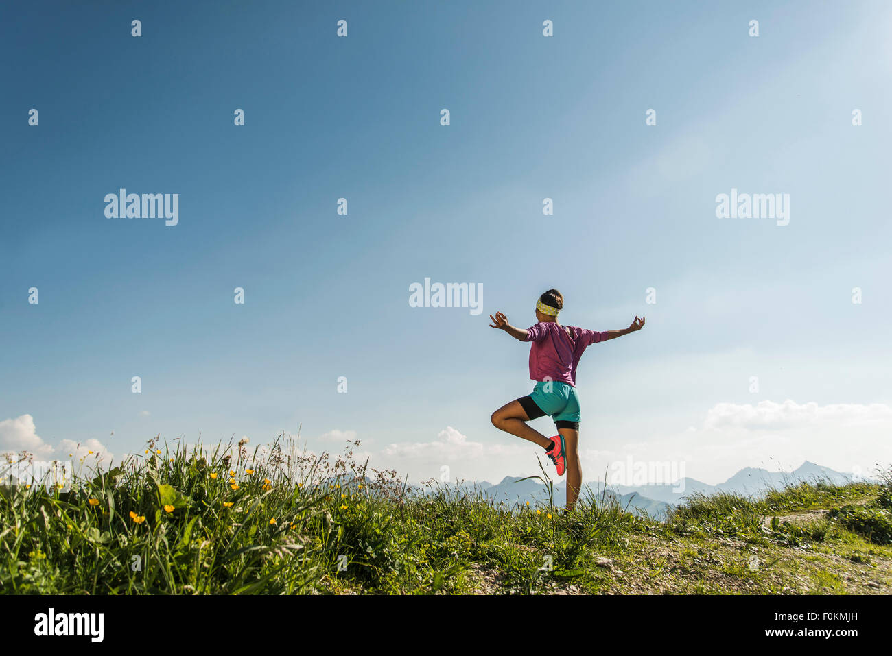 Austria, Tyrol, Tannheim Valley, young woman exercising in mountains Stock Photo